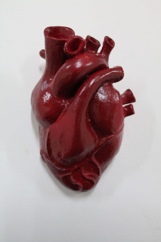 Heart ceramic sculpture in vibrant red color, showcasing intricate anatomical design for home decor.